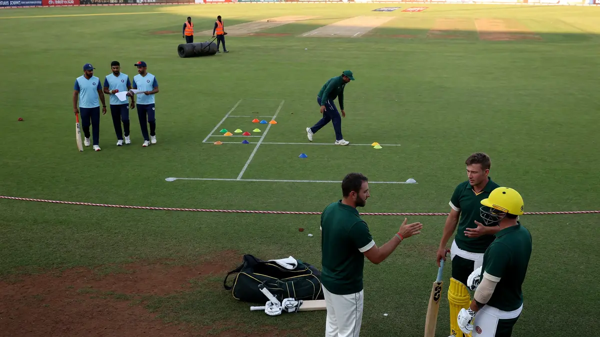 Fielders in close catching positions as a spinner prepares to bowl on a dry T20 pitch